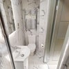 Photo 5: Ensuite: Marble tiles, shower, mirror and towel rail.