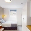 Photo 6: Self-contained studio: kitchenette, built-in fridge, sink, sofa and ensuite.
