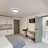 Photo 4: Self-contained studio: kitchenette, built-in fridge/washing machine, sink, sofa and ensuite.