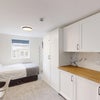 Photo 8: Self-contained studio: kitchenette, built-in fridge, sink, sofa and ensuite