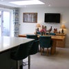 Photo 4: Breakfast bar and dining table, with triple bi-fold doors to garden