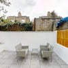 Photo 9: Garden: Spacious tiled patio with outdoor table and chairs