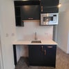 Photo 2: Room with kitchenette / Wash basin / Microwave / Storage cabinets / Fridge freezer