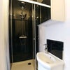 Photo 3: The en-suite includes a cubicle shower with rainflow showerhead, mirrored cupboard, sink and toilet.