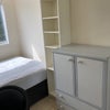 Photo 3: Room 3 showing bed, cupboards & edge of window