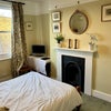 Photo 1: Large double bedroom with built-in cupboard, original Victorian fireplace and bookshelf for storage