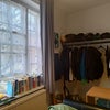 Photo 7: Room as seen from the bedside. Mirror and Clothing rack, desk. More storage outside in the hallway!