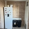 Photo 7: Fridge and recycling bin