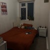 Photo 2: Room 1 - wardrobes not included, comes with bedside shelf and clothing hanging rack
