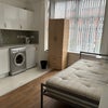 Photo 4: Hrd floor double room with washer fridge sink and tap
