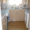 Photo 9: Kitchen with washing machine and dryer; fridge/freezer and all white good and cooking utensils/pans 