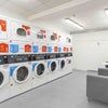 Photo 5: On-site laundry room with multiple washers and dryers for quick and easy washing.