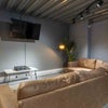 Photo 7: Comfortable cinema-style lounge with large TV and sofas for movie nights