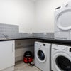 Photo 8: Laundry Room (Two washing Machines one Tumble Dryer and a Sink)