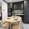 Photo 4: A stylish folablr dining table that creates a warm, welcoming space for a calm, leisurely meal