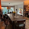 Photo 7: Open-plan dining area filled with natural light and warm mid-century style.