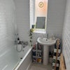 Photo 8: Bathroom with hand shower one end and mounted powerful shower on other 