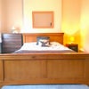 Photo 2: Solid pine kingsize bed.