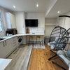 Photo 3: Kitchen from the other end, note TV on wall