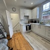 Photo 2: Kitchen showing cooking and seating areas