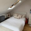 Photo 4: Bright loft room with skylights, double bed, built-in storage, and private fridge.