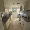 Photo 3: Kitchen with induction hobs, microwave, oven, full size fridge/ freezer and a washer/dryer