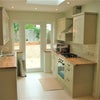Photo 5: Modern clean kitchen opens to garden