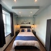Photo 4: Double ottoman bed accessed from both sides with built in bedside lamps