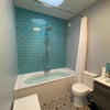 Photo 4: Two basins, lit mirrors over, double ended bath with shower over.