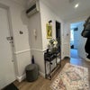 Photo 5: Hallway with shoe rack and storage cupboard