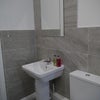 Photo 13: Separate Utility with sink, toilet, washing machine and tumble dryer