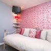 Photo 3: Cosy room with TV and feature wallpaper