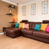 Photo 5: Bright lounge with comfy corner sofa