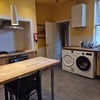 Photo 8: The ground floor main kitchen showing the washing maschine and drier