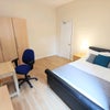 Photo 2: Furnishings include a double bed, bedside table, chest of draws, large wardrobe, desk and a chair.