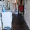 Photo 9: Utility room with washing machine and storage