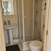 Photo 5: Shower cubicle, toilet and a sink