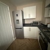 Photo 7: Kitchen with fridge freezer and gas hob 