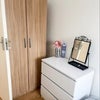 Photo 3: Lots of storage! Both a wardrobe and chest of draws tucked nicely away in the corner- leaving lots o