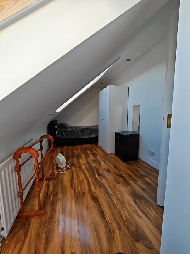 Bright loft conversion room with adjacent bathroom Main Photo
