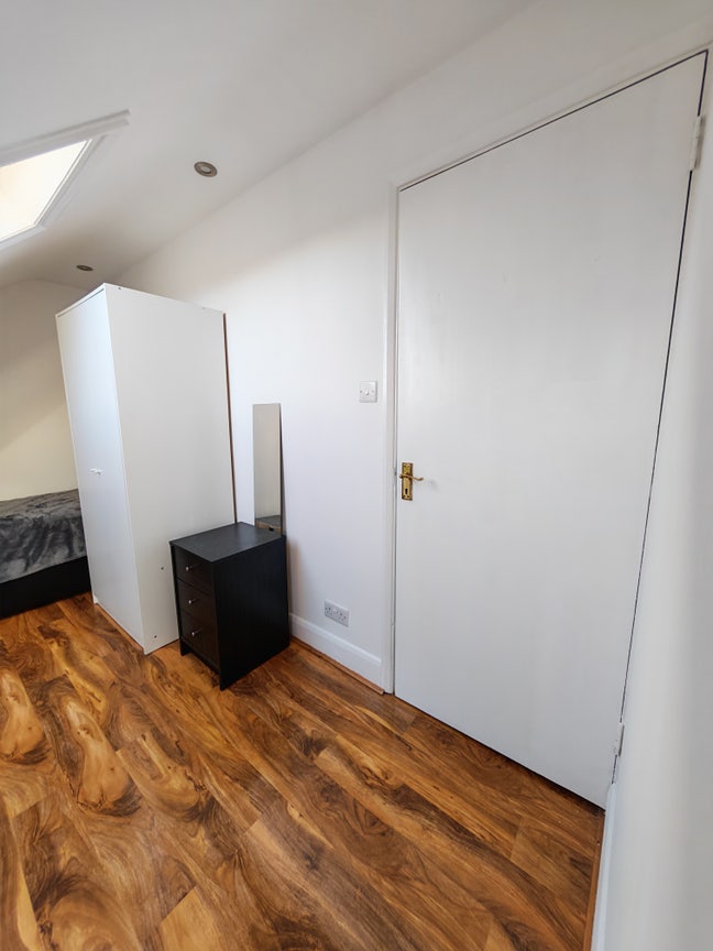 Bright loft conversion room with adjacent bathroom Main Photo