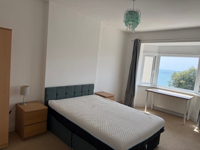 Large dble bed with sea views. Moments to beach.  Main Photo