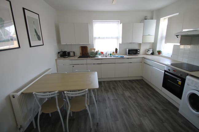 Large bedroom with private fridge in clean home Main Photo