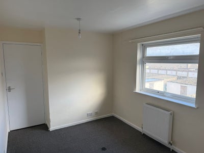 A small, unfurnished room with cream walls, grey c Main Photo